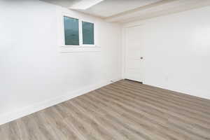 Basement with hardwood / wood-style flooring