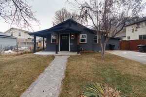 Bungalow-style house with a front lawn