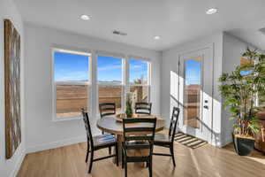 Dining area with light hardwood / wood-style floors