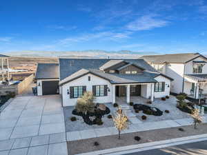 View of front of property featuring a garage, a mountain view, and a porch