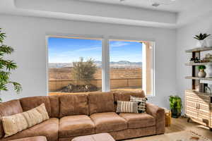 Living room with a healthy amount of sunlight, a mountain view, and light wood-type flooring