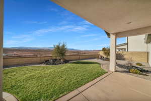 View of yard with a mountain view and a patio area