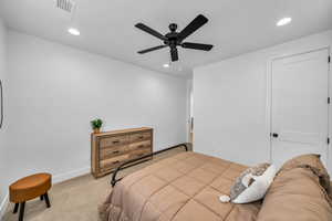 Carpeted bedroom featuring ceiling fan