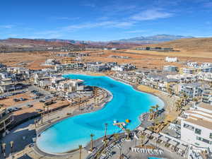 Birds eye view of property with a water and mountain view