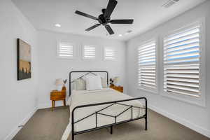 Carpeted bedroom with ceiling fan