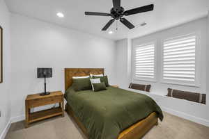 Bedroom with ceiling fan and carpet