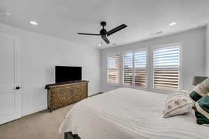 Bedroom with light carpet and ceiling fan