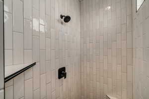 Room details featuring a tile shower