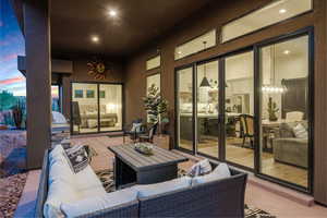 Patio terrace at dusk featuring an outdoor living space