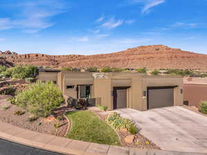 Adobe home with a garage and a mountain view