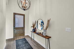 Entryway featuring an inviting chandelier and hardwood / wood-style floors