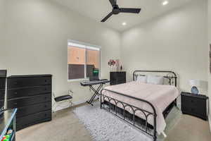 Carpeted bedroom featuring ceiling fan