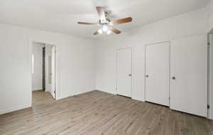 Unfurnished bedroom featuring ceiling fan and light wood-type flooring