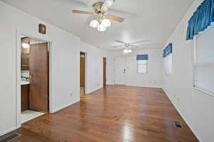 Empty room featuring wood-type flooring and ceiling fan