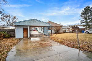 View of back of property with a carport