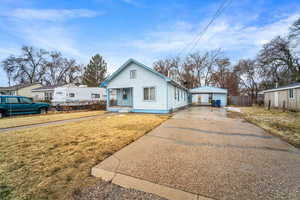 Bungalow-style house with a garage, a front lawn, and a porch