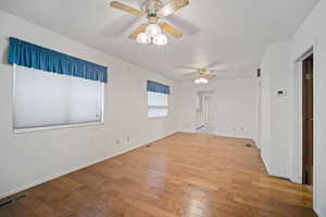 Empty room featuring ceiling fan and light wood-type flooring