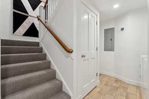 Staircase featuring electric panel