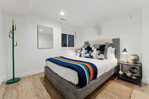 Bedroom with crown molding and light hardwood / wood-style floors