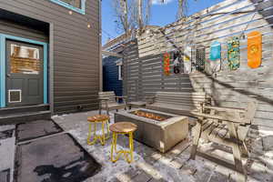 View of patio with an outdoor fire pit