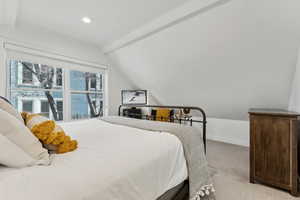 Bedroom featuring lofted ceiling with beams