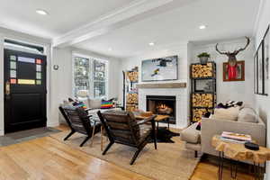 Living room featuring hardwood / wood-style floors and crown molding