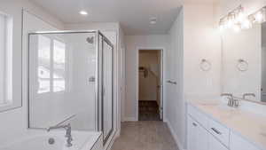 Bathroom with vanity, plus walk in shower, and tile patterned flooring