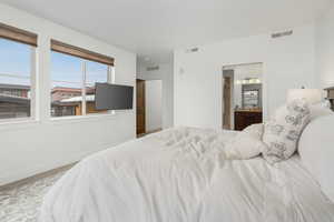 Carpeted bedroom with ensuite bathroom