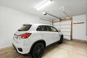 Garage featuring a garage door opener