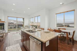 Kitchen with dishwasher, a mountain view, a kitchen island with sink, and sink