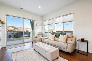 Living room with a water view and light wood-type flooring