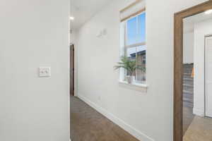 Corridor with light colored carpet