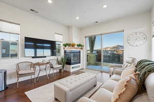 Living room featuring dark hardwood / wood-style floors and a multi sided fireplace