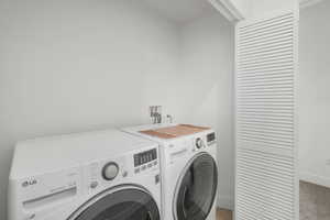 Laundry room with washer and clothes dryer