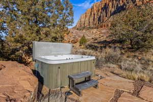 View of patio featuring a mountain view and a hot tub