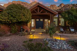 Exterior entry at dusk featuring a mountain view and a patio