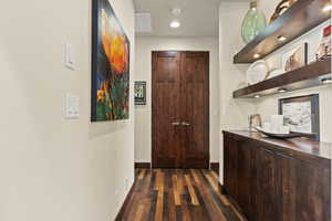 Hall featuring dark wood-type flooring