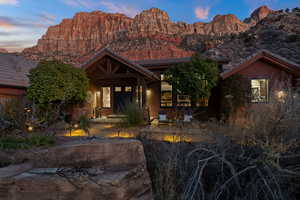 View of front of property featuring a mountain view and a patio area