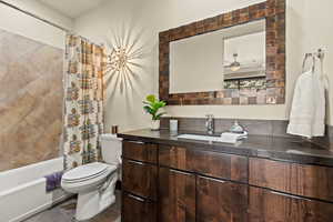 Full bathroom with tile patterned floors, vanity, toilet, and shower / bath combo