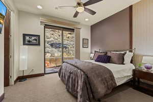 Bedroom featuring light colored carpet, access to exterior, and ceiling fan