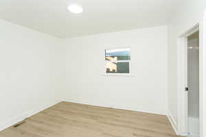 Spare room with light hardwood / wood-style floors