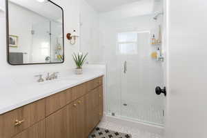 Bathroom with vanity with Euro glass style doors.