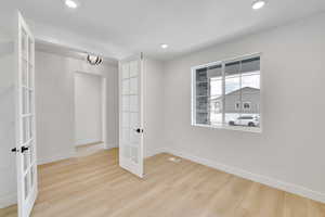 Interior space with recessed lighting, baseboards, french doors, and wood finished floors
