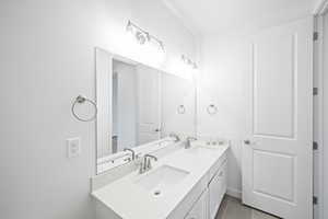 Bathroom with tile patterned floors and vanity