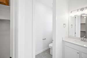 Bathroom featuring tile patterned floors, vanity, and toilet