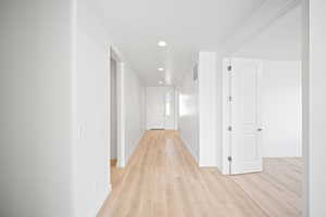 Hallway with light hardwood / wood-style floors