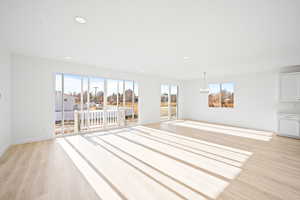 Interior space with a chandelier and light wood-type flooring