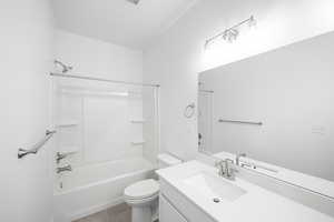 Full bathroom featuring vanity, tile patterned floors, shower / washtub combination, and toilet