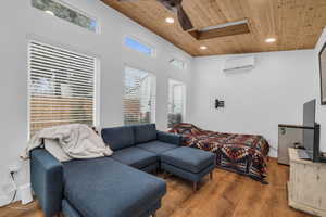 Studio/Office with lofted ceiling, a wall mounted air conditioner, hardwood / wood-style flooring, and wooden ceiling