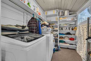 Washroom with washer and clothes dryer, wooden ceiling, and carpet flooring